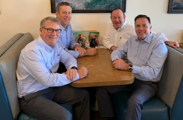 The four WSA founders seated together at a breakfast booth